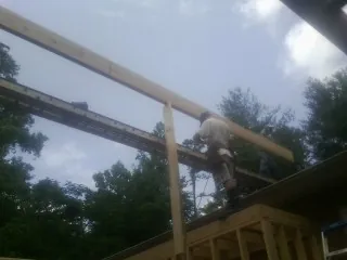 Carpenter setting a ridge beam over a new addition frame — Ice Dam Removal by Roofing Brothers in Idaho Springs